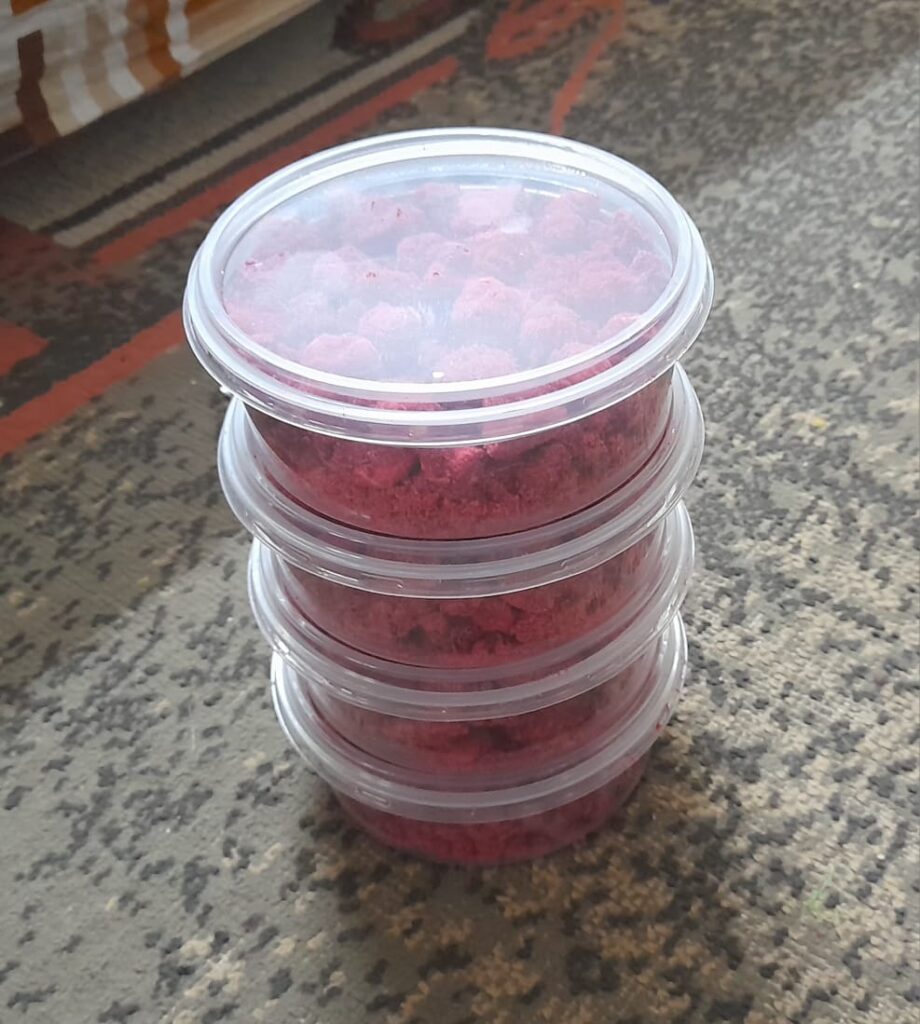 Packaged dried mango candy in retail containers at Bwagabei Farms value addition center.