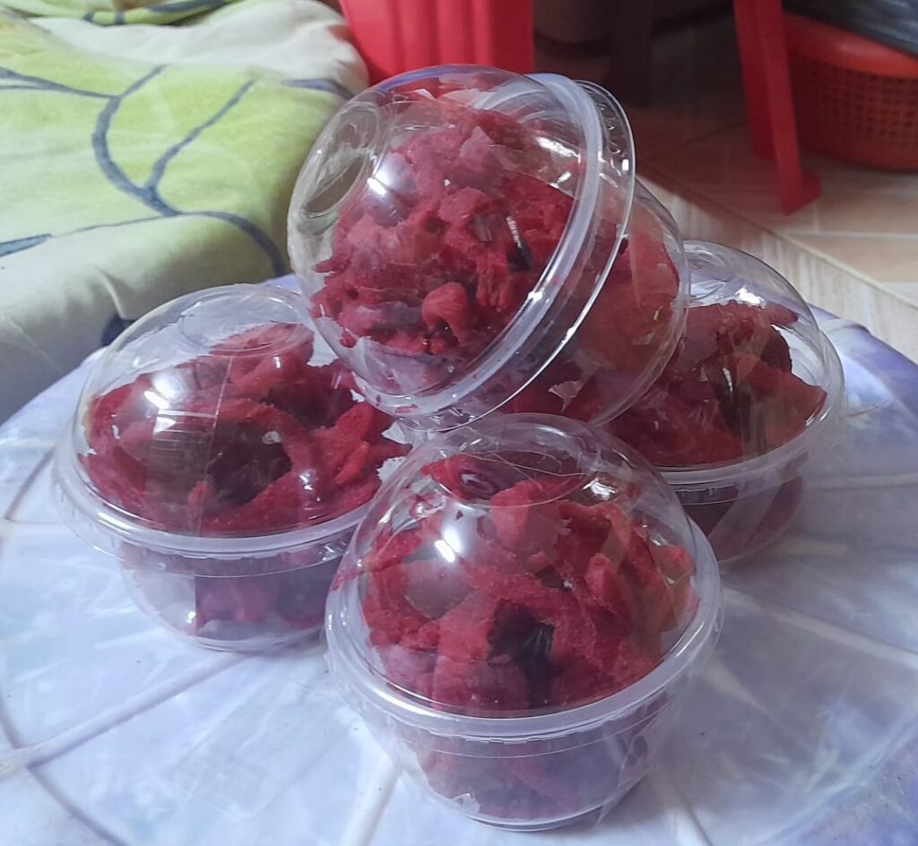 Packaged dried mango candy (Achari ya Embe) in retail containers at Bwagabei Farms.