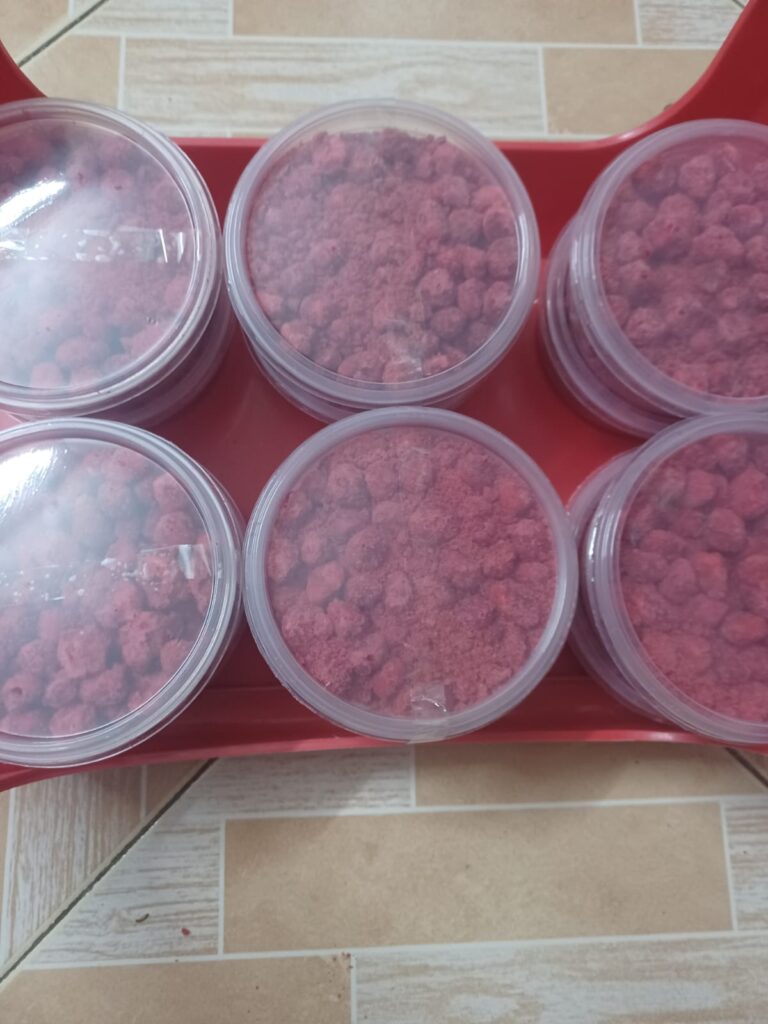 Stacked containers of mabuyu baobab candy in clear plastic jars at Bwagabei Farms.